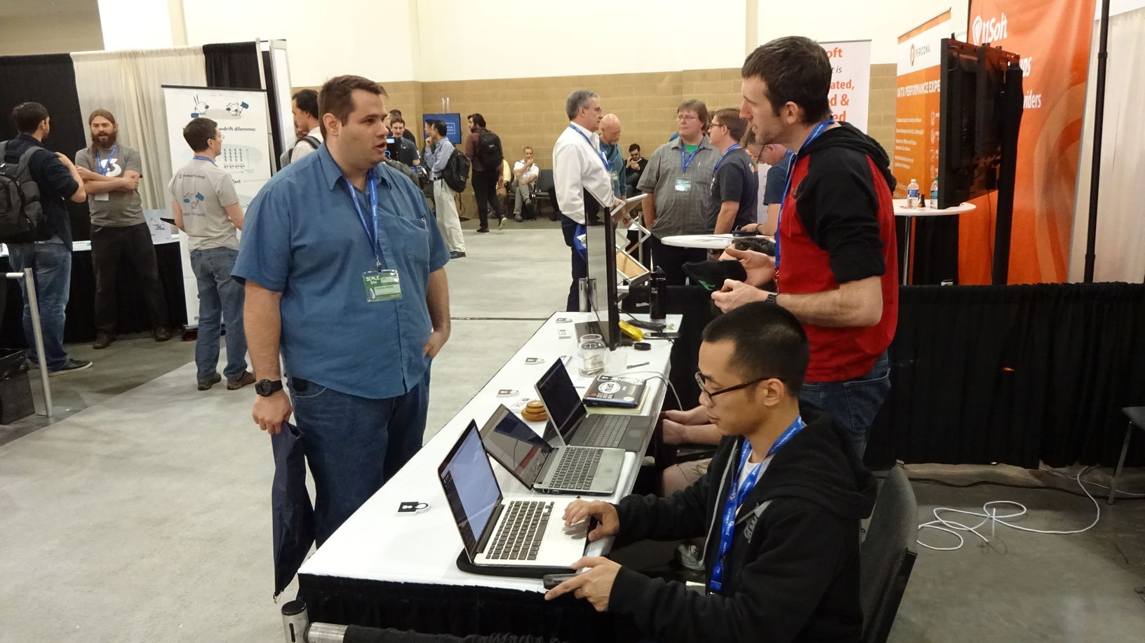 Chuong Vu (near) and Greg Mullen (far) explaining Tox to an expo attendee